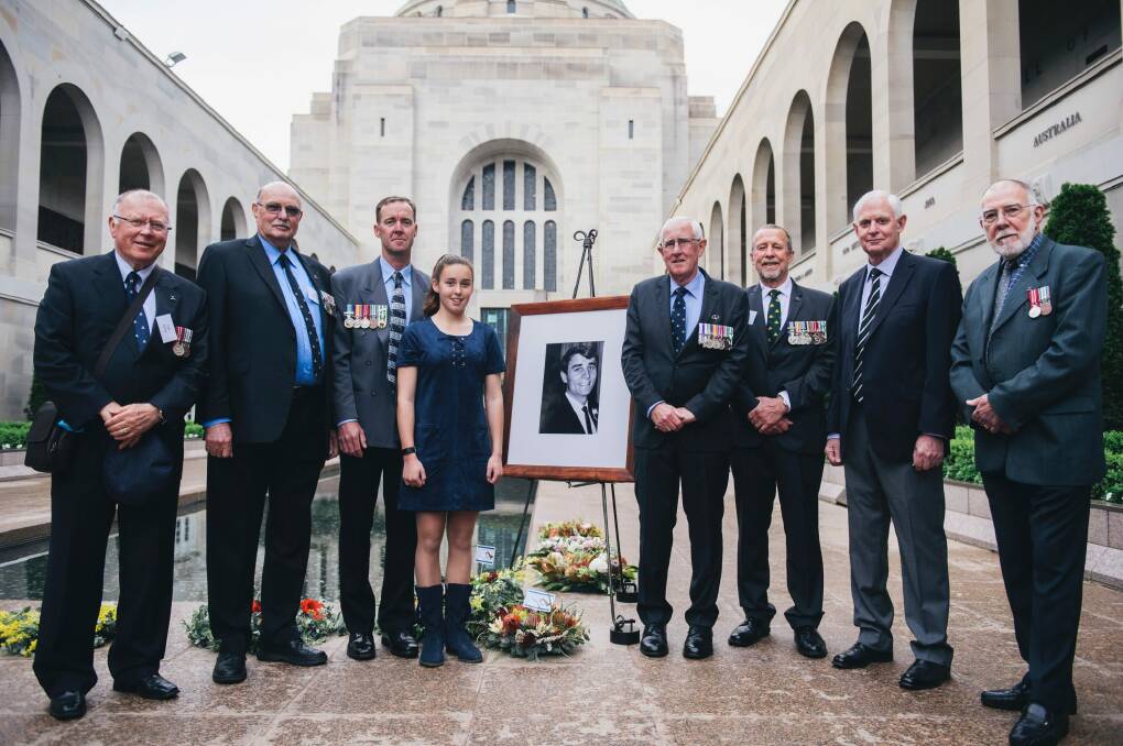 The last post ceremony for Terrance Langlands at the National War Memorial. (L-R) Members of Langlands' class Ian Kelly, Greg Monteith, Mick Woolan, David Gray, Terry Wesley-Smith and Ian Paton with Langlands' nephew David Langlands with his daughter Amber Langlands. Photo: Rohan Thomson