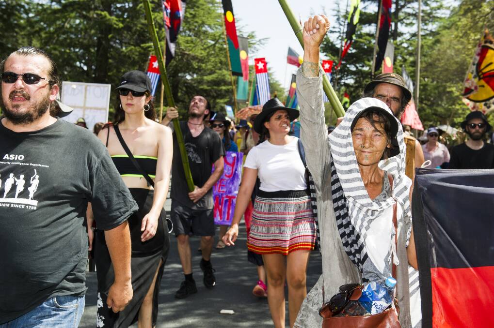 Invasion Day protesters march through Canberra on their way to the Aboriginal Tent Embassy on Saturday morning. Photo: Dion Georgopoulos