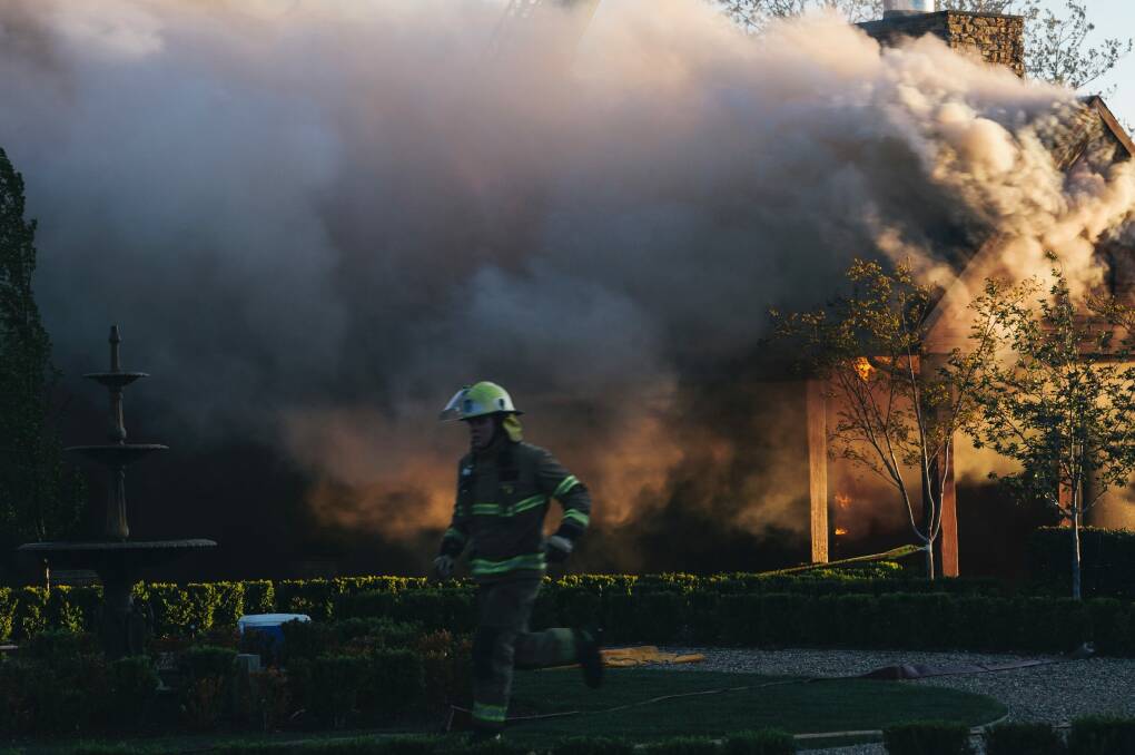 Emergency services work to extinguish the fire on Thursday Photo: Rohan Thomson