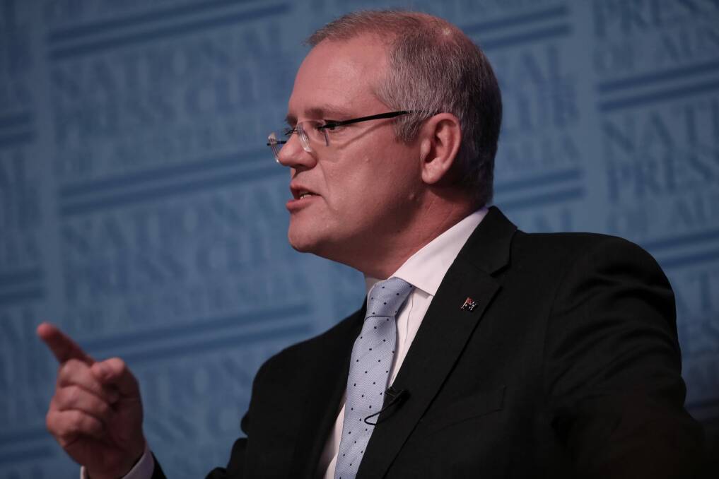 Treasurer Scott Morrison, speaking at the National Press Club, said it was time for the banks to "pony up" and absorb the tax. Photo: Andrew Meares