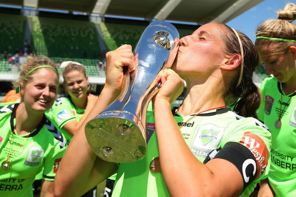 Canberra United captain Nicole Begg kisses the championship trophy after last year's grand final victory. Photo: Paul Kane