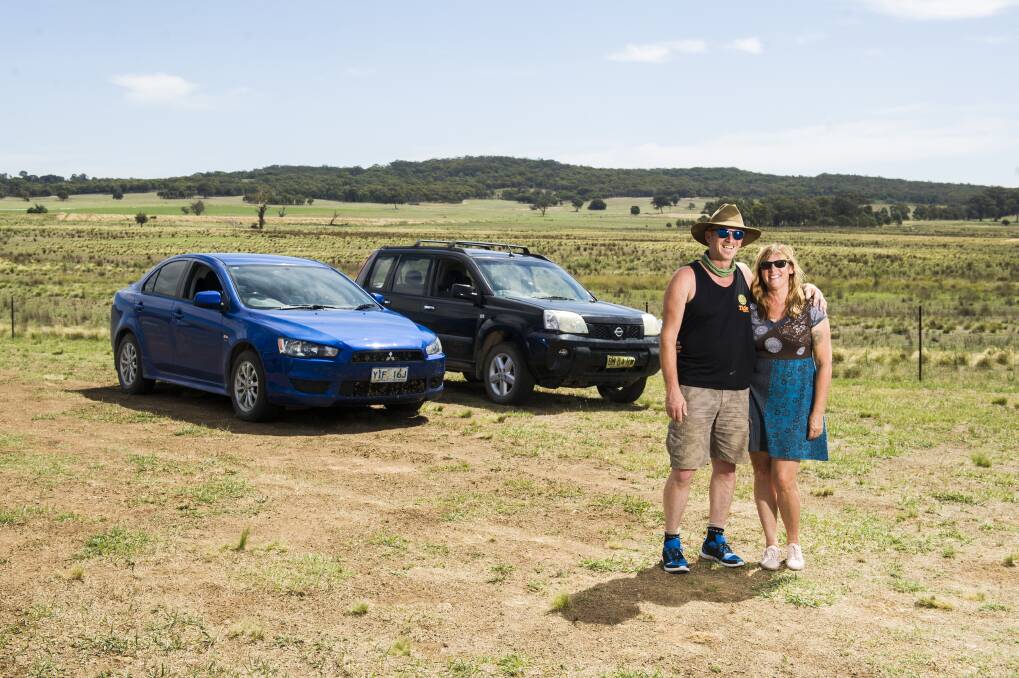 Jay Dryden and Jane Penders live and work in Canberra but spend weekends on a property  they own in Gunning. They always fill up in Gunning because petrol is much cheaper than in Canberra. Photo: Dion Georgopoulos