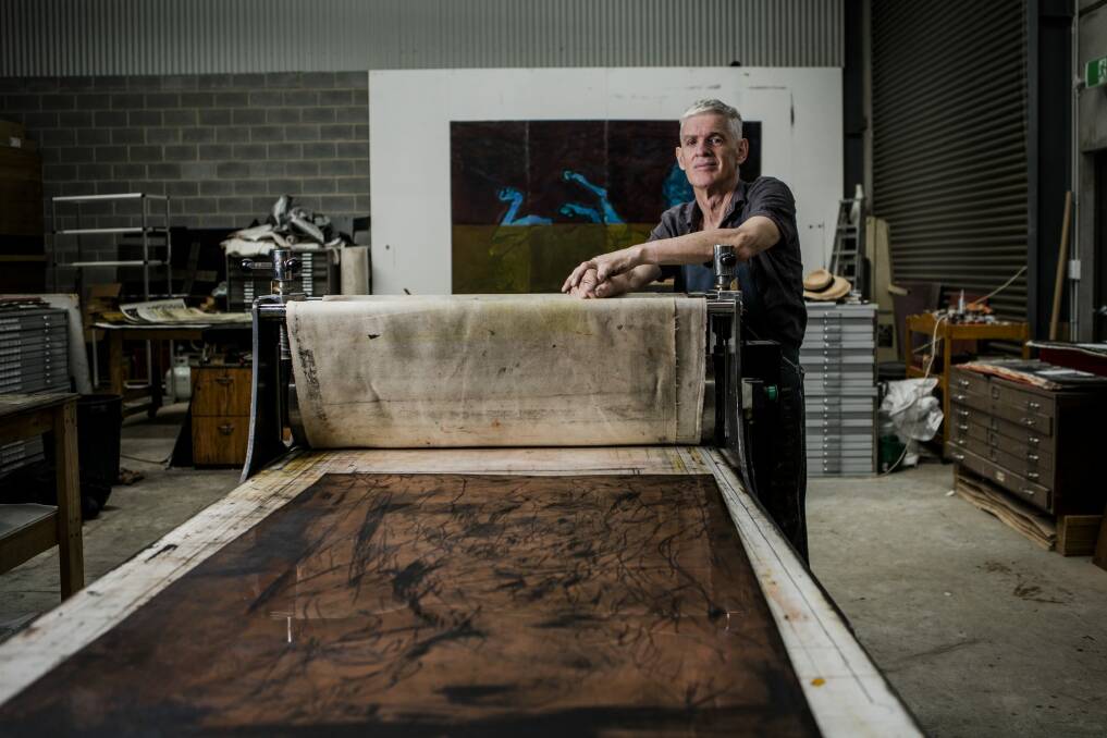 Printmaker John Loane with the etching press in his studio at Mitchell. Photo: Jamila Toderas
