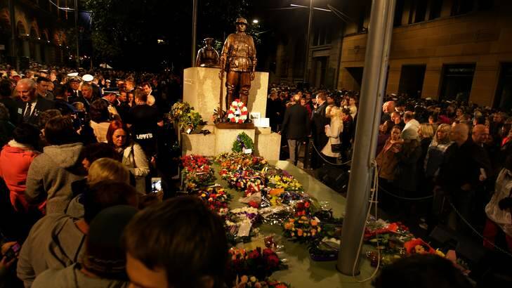 Large crowds pay their respects at the centotaph moments after the 99th ANZAC dawn service at the Martin Place war memorial, Sydney. Photo: Kate Geraghty