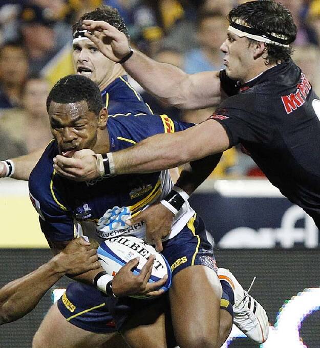 Henry Speight of the Brumbies is tackled by Marcell Coetzee of the Sharks. Photo: Getty Images