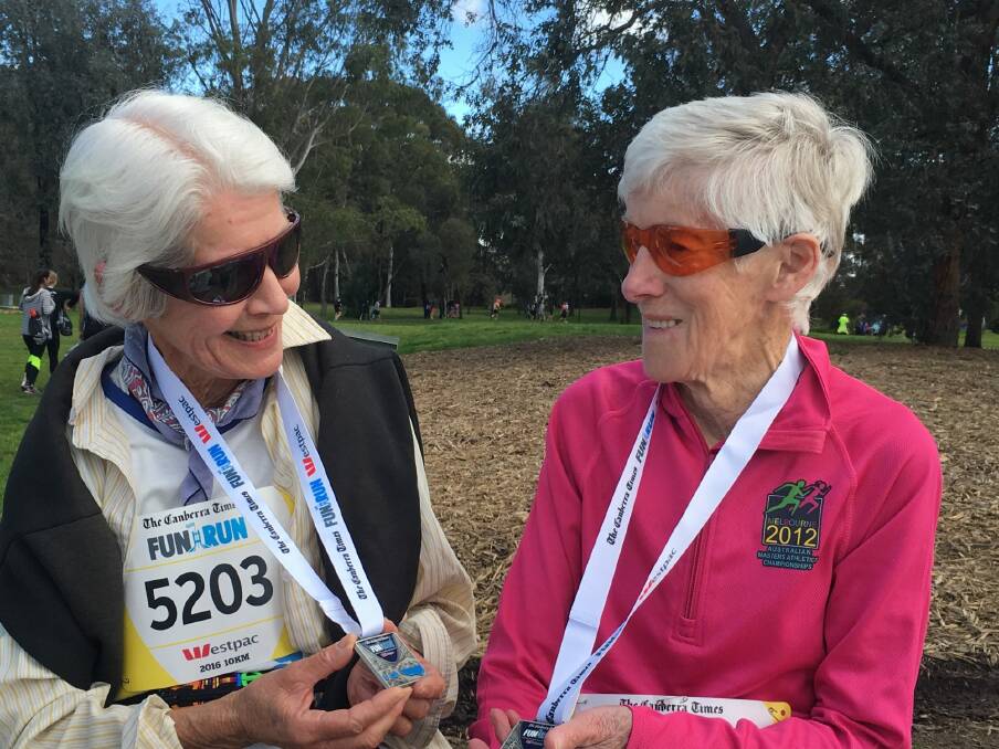 Suzanne Counsel, left, and Anne Young, at the end of the Canberra Times 10km fun run on Sunday, their 30th event. Photo: Kirsten Lawson