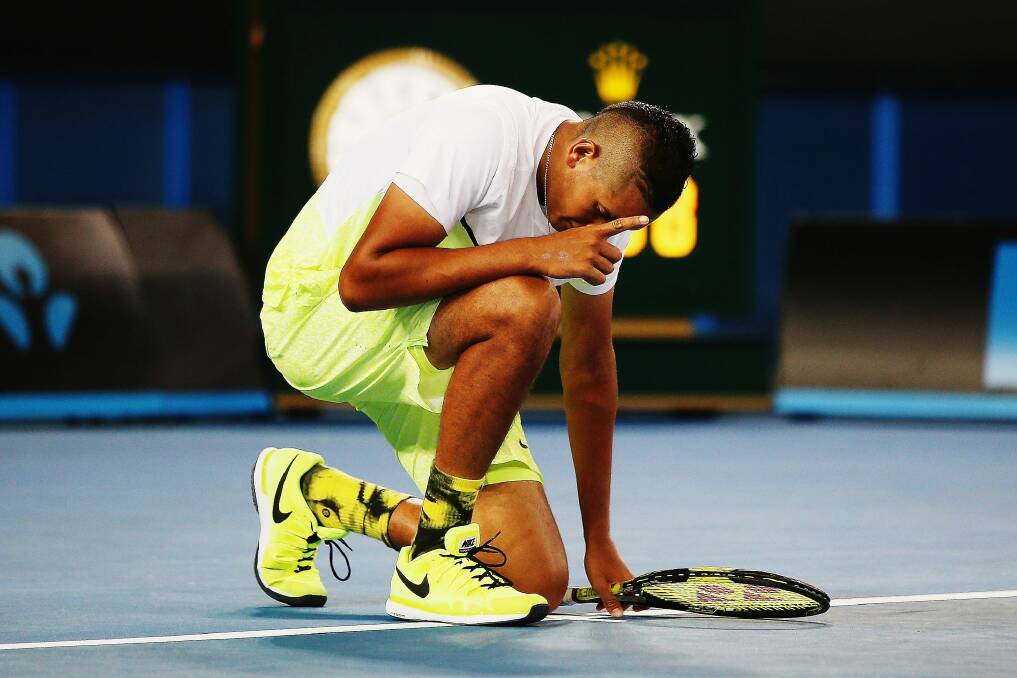 Nick Kyrgios takes a moment to remember his grandmother after winning the first round of the Australian Open. Photo: Getty Images