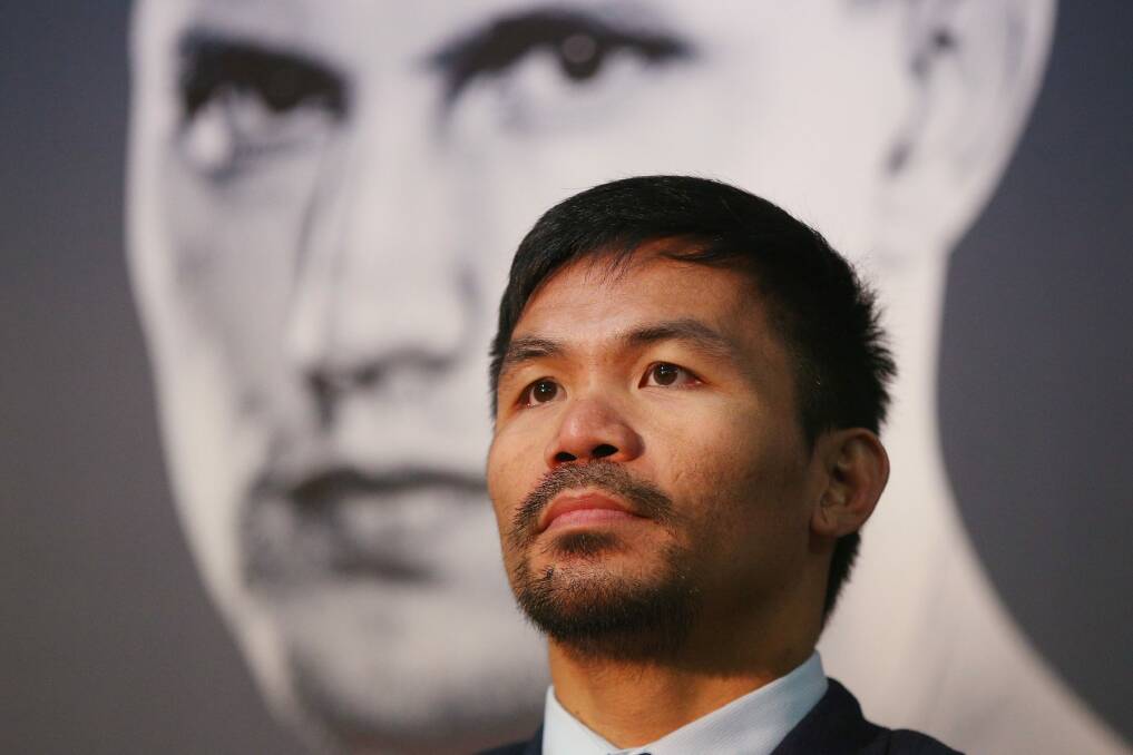 He's behind you: Manny Pacquiao speaks to the media as a picture of Jeff Horn looms over him. Photo: Getty Images
