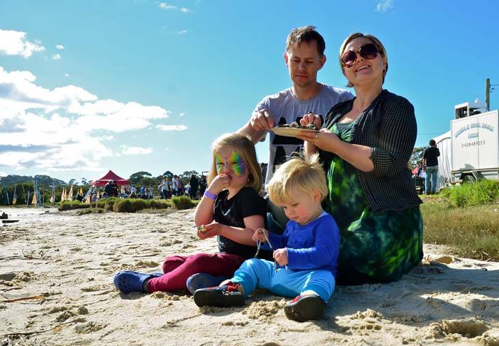 Kaleen family Annelise Fox and Warwick Pitt, with their children Emilia, 4, and Arlo, 1, enjoy freshly-shucked oysters at the Narooma Oyster festival. Photo: Tim Burke
