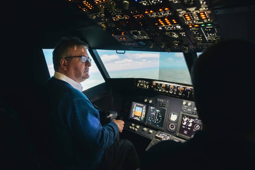 Canberra Times journalist Ron Cerabona flies a plane with pilot Nick Walsh at the Flight Simulator in Fyshwick. Photo: Rohan Thomson
