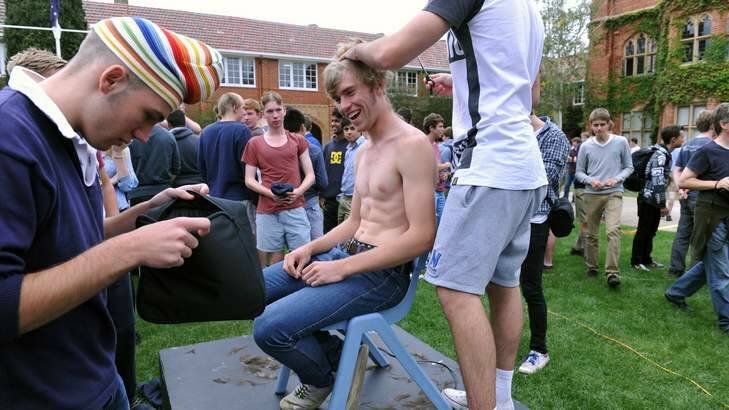 Year 12 student, Oliver Perillo, has his locks removed. He lost his father to the disease when he was only 11 months old. Photo: Graham Tidy