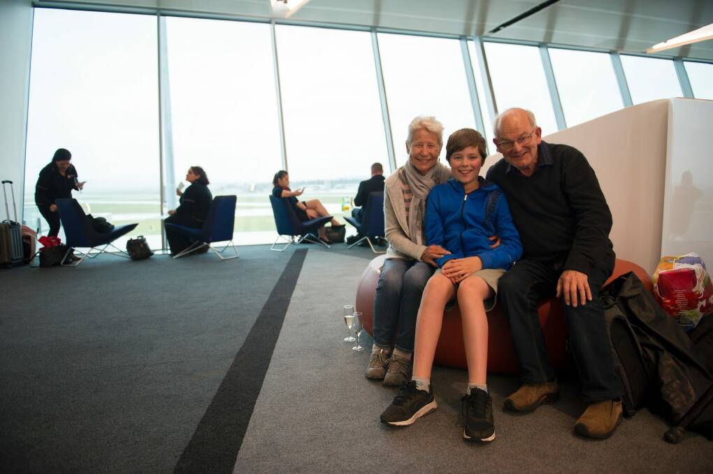 Martin and Sue Neveu with their grandson Ben Schmidt, 13, were catching the first Singapore Airlines Flight from Canberra to Wellington to visit family. Photo: Jay Cronan