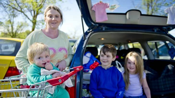 Rachel Vernon unloads the groceries after doing the shopping with her children  Harry, 6, Josie, 4, and Lilly, 15 months. Photo: Jay Cronan