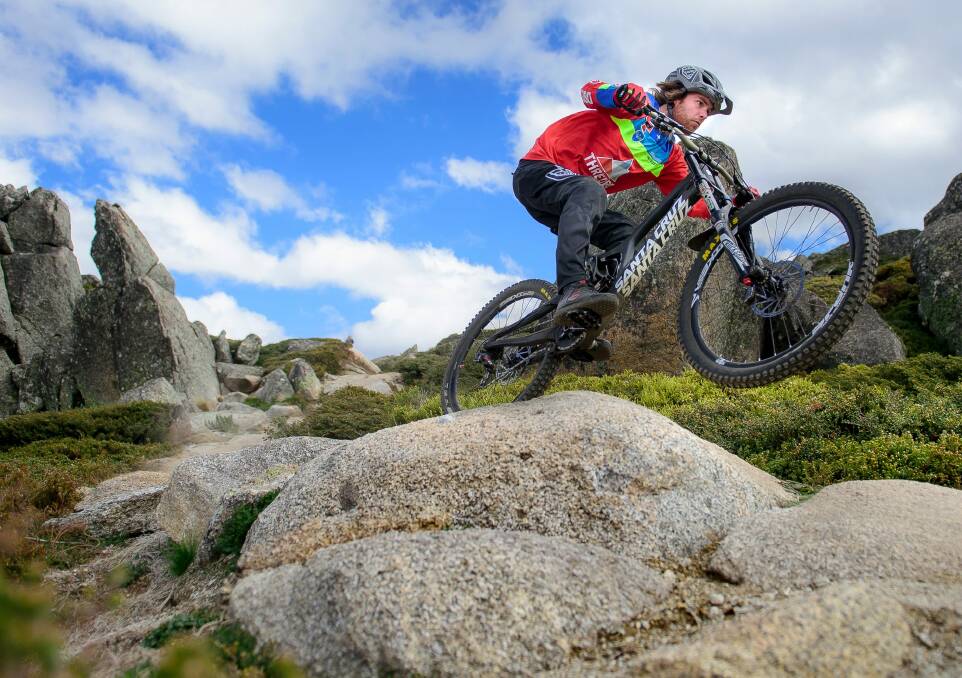 Tim Windshuttle hits a jump with speed on Thredbo's All-Mountain Trail. Photo: Sitthixay Ditthavong