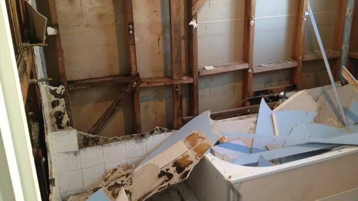 Asbestos sheeting removed from the walls can be seen placed in the bath. Photo: Supplied
