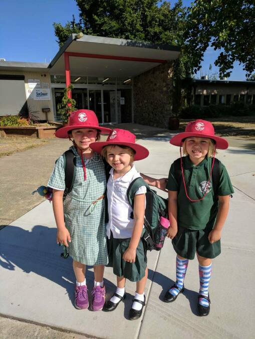 Freyja Christiansen  got to have one day at kindy at Yarralumla Primary School before starting cancer treatment. She is with her big sisters Brynn, and Inge,  Photo: Supplied
