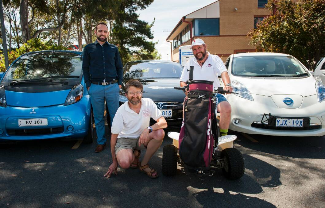 Tesla car owner, Slava Kozlovskii with members of the Canberra electric vehicle association, Peter Campbell and Mark Hemmingsen take part in the Renewable Energy Day in Tuggeranong.  Photo: Elesa Kurtz