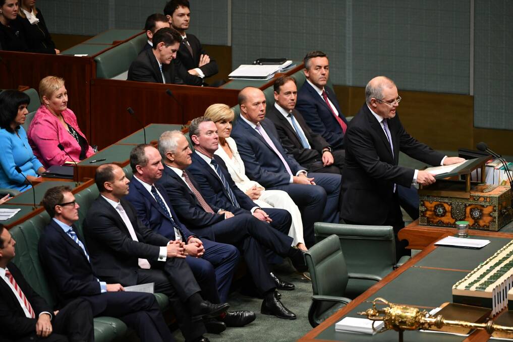 Coalition ministers watch on as Scott Morrison delivers the budget speech.