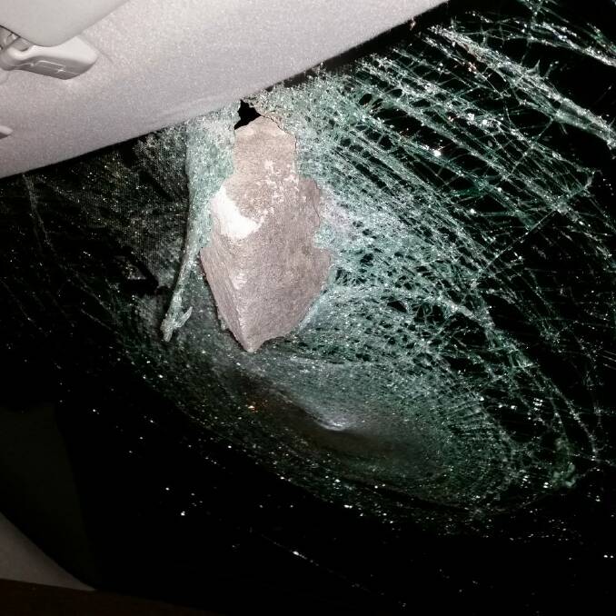 A woman was lucky to escape injury when a rock smashed through her car windscreen while she drove on Northbourne Avenue.