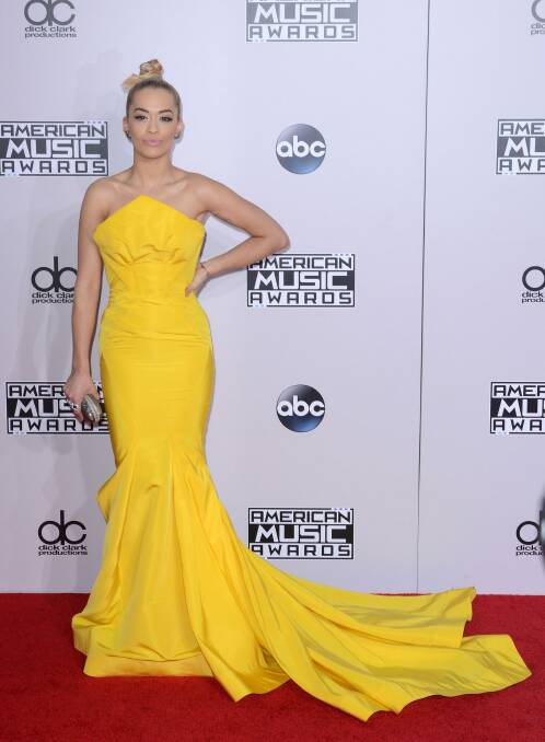Rita Ora, in Zac Posen, had her hair done in the back of a taxi en route to the 2014 AMAs.