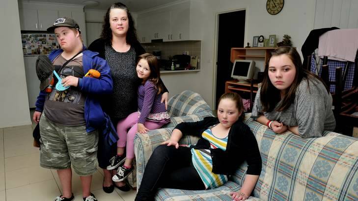 Doing it tough ... Elizabeth Friend at home with four of her five children, from left, L-R Thomas, 16, Ashleigh, 4, Sarah, 10, and Brianna, 12. Photo: Melissa Adams