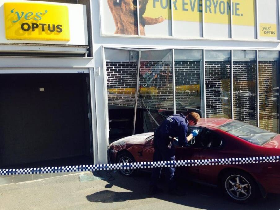Smashed: Police check for evidence after the apparent ram-raid. Photo: Henry Belot