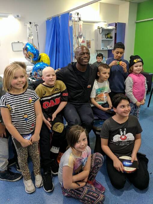 Seal visiting the Sydney Children's Hospital this week where he caught up with Canberra girl Freyja Christiansen (right in beanie) who is being treated there for a rare form of cancer and her sisters Inge (left) and Brynn (seated left) Photo: Supplied