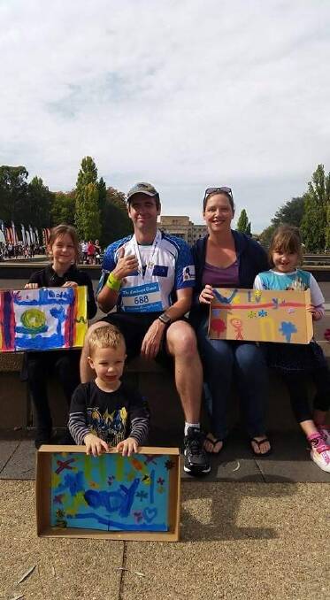 Jason McNamara with his family after he completed the Canberra Times Running Festival Marathon last year. Photo: Supplied