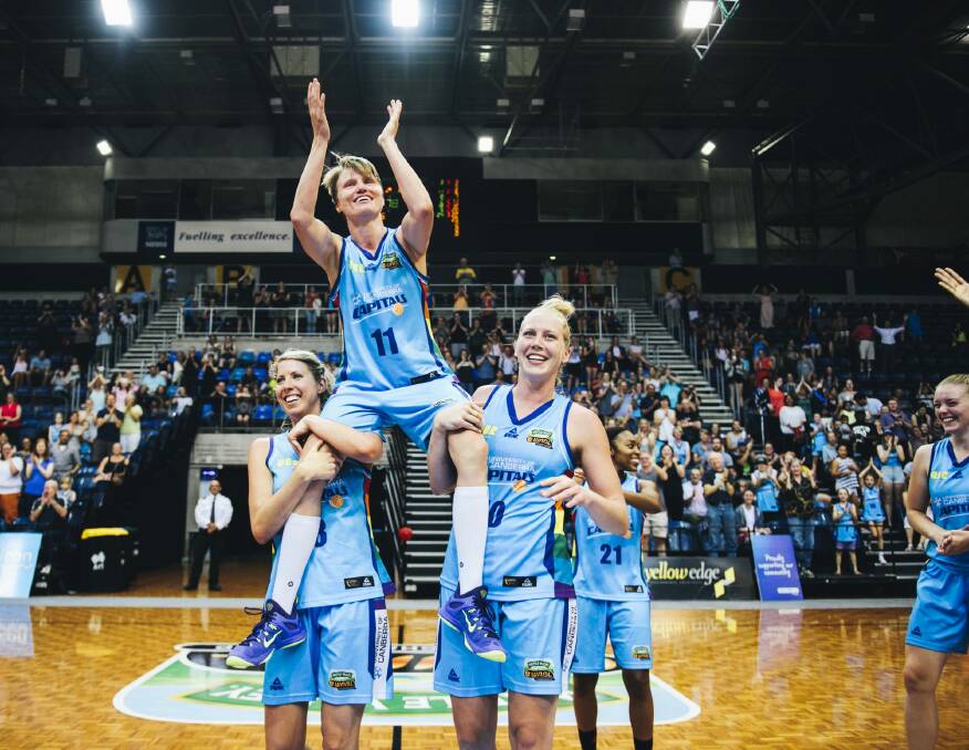 Jess Bibby is carried off by Canberra Capitals teammates Carly Wilson and Abby Bishop after her final WNBL game last season. 
The Canberra Times Photo: Rohan Thomson