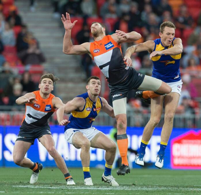 Duel: Shane Mumford of the Giants and Drew Petrie contest the bounce. Photo: AAP