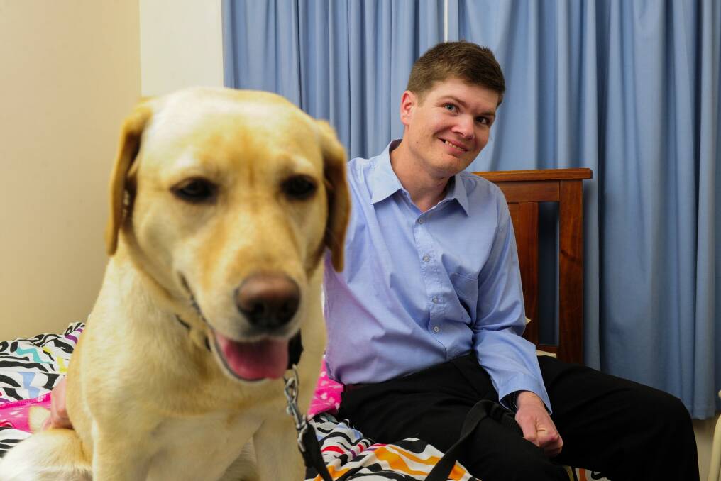 Ronnie Lawrence with his assistance dog Sandy, which he received through the NDIS. Photo: Melissa Adams