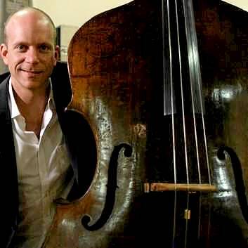 Maxime Bibeau and his historic bass, which was made in the late 16th century. Photo: Will Huxley, courtesy ACO