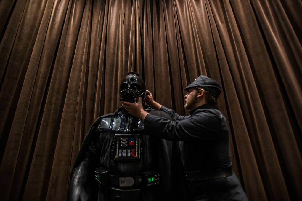 What's under the mask? Goulburn Darth Vader Jason Feldner gets kitted out with the help of fellow Legioner Matt Mulcahy. Photo: Karleen Minney