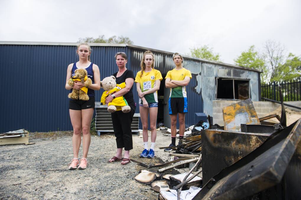 Woden athletics club users Caitlin Hanna, Woden Thunder Little Athletics club Secretary Mel Harding, Grace Brennan and Erek Lukowski are disappointed to see a Shed containing sports equipment at the Woden Athletics Park destroyed due to arson.  Photo: Dion Georgopoulos