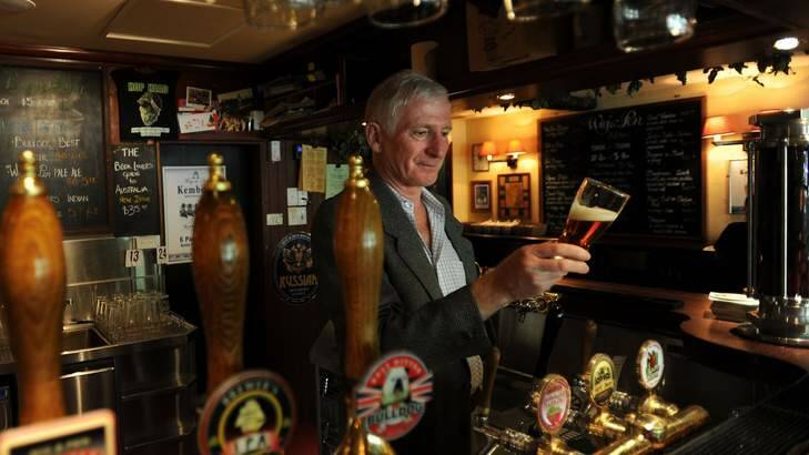 Owner of the Wig and Pen, Lachie McOmish , behind the bar of the Civic establishment. Photo: Lannon Harley