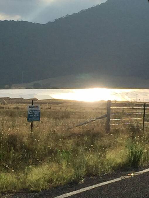 Glare from the Royalla solar farm as seen from the Monaro Highway at 6.40pm on January 23 this year. Photo: Supplied