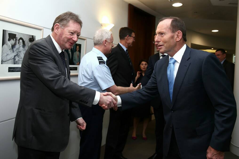 Dr Watt greets then Prime Minister Tony Abbott in 2014. Photo: Alex Ellinghausen