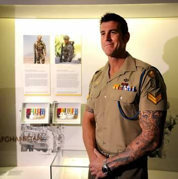 Victoria Cross recipient Corporal Ben Roberts-Smith pictured with his newly installed panel and medal display in the Hall of Valour, at the Australian War Memorial in 2011. Photo: Marina Neil