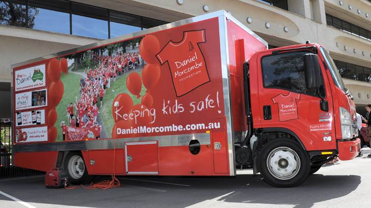 Big Red arrives in Canberra to deliver the child safety message. At the AFP HQ in Barton, with Bruce and Denise Morcombe, parents of Daniel. Photo: Graham Tidy