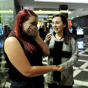 Cassie Ramsay and Lauren Blewitt take a moment to collect themselves after their meeting with Harrison Craig. Photo: Jay Cronan