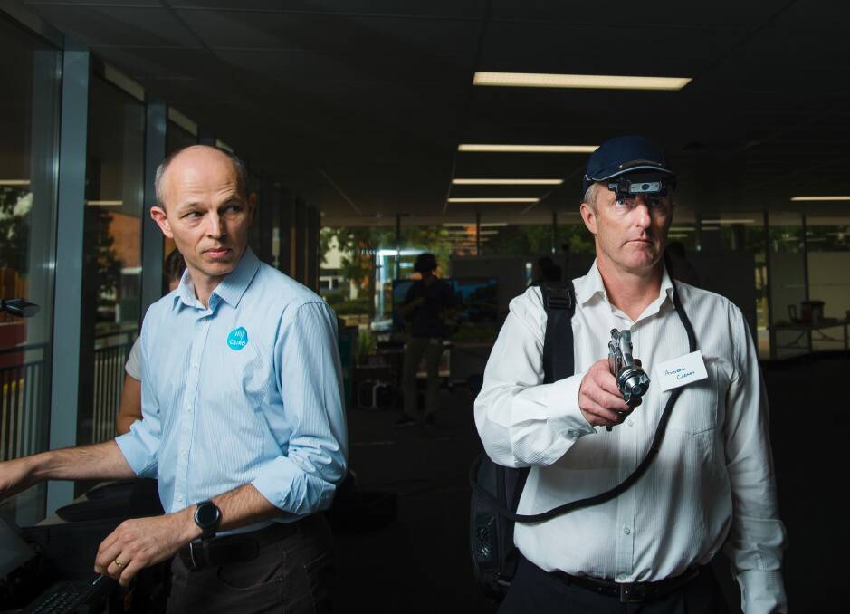 CSIRO 3D visualisation engineer Craig James and Clearz director Andrew Cleary demonstrate the fountx cap allowing a remote expert to see what operators are doing on the ground.  Photo: Sitthixay Ditthavong
