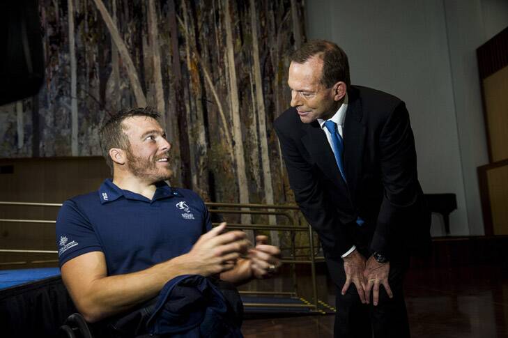 Paralympian Kurt Fearnley speaks with Opposition Leader Tony Abbott at the announcement. Photo: Rohan Thomson