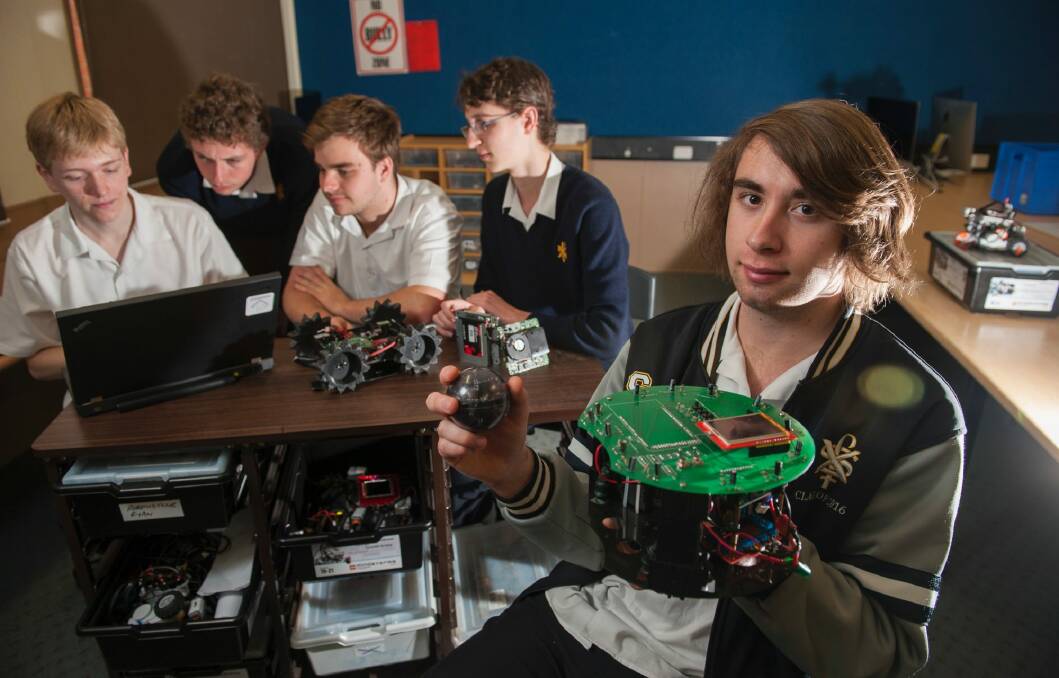Year 12 student Robert Kaz 18 (right) with his team's soccer robot will be competing in the Robocup Junior Australian Championships next weekend in Sydney, with fellow students Aaron Maggs, Matthew Williams, Riley Cockerill and Jack Williams with their rescue robot. Photo: Elesa Kurtz