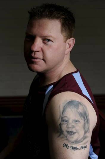 Craig Robberds shows the tattoo of his daughter Gabby who died of Cerebral palsy in 2010.
