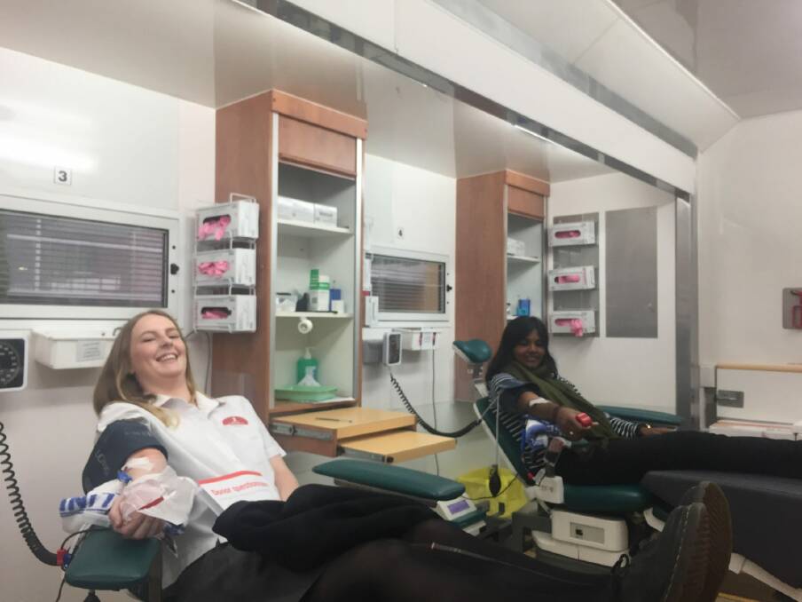 Sophie New, 17 (left) was donating blood for the first time on Friday. Arthy Ananthapavan, 21 (right) has a rare blood type that makes her donations extra valuable. Photo: Finbar O'Mallon