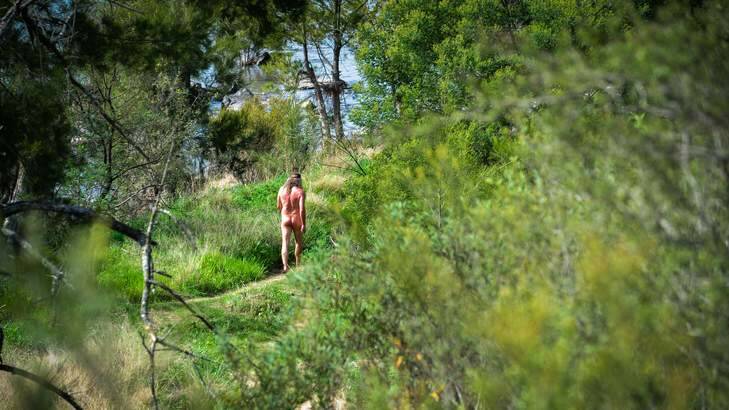 A man enjoys the warm weather at the Kambah Pool nudist area. Photo: Katherine Griffiths