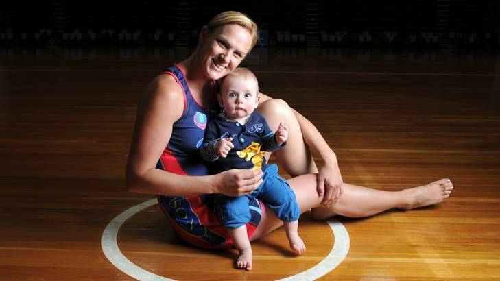 Retired former Australian netball captain Sharelle McMahon with her son Xavier. Netball Australia is more supportive of mums who want to bring their children on tour. Photo: Wayne Taylor