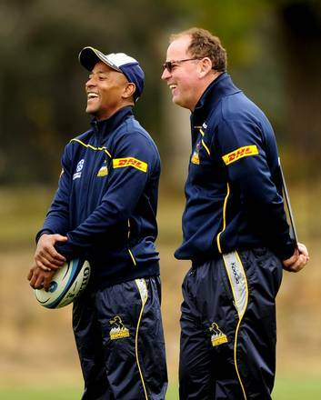 A relaxed Jake White, right, enjoys a laugh with George Gregan at Brumbies training yesterday. Photo: Stuart Walmsley