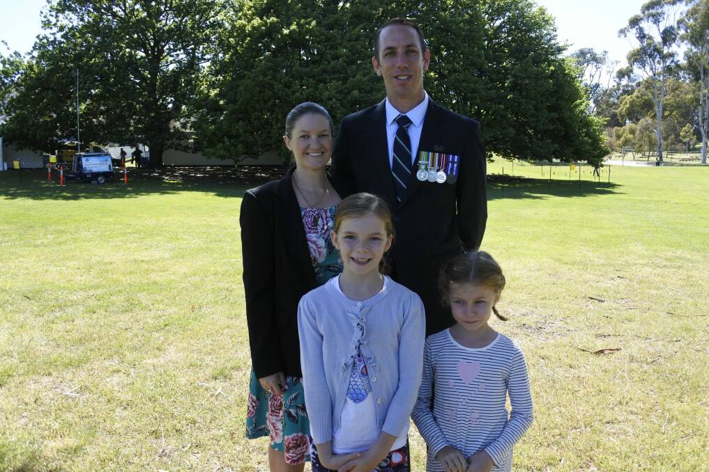 Townsville couple Caetlin and Simon Watch with their daughters Emily, eight, and Hannah, six, took time to reflect at the Remembrance Day ceremony. Photo: Emily Baker