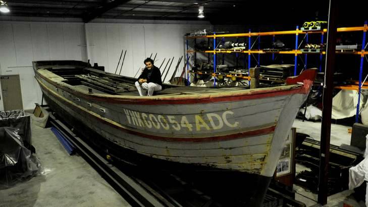 Former National Museum senior conservator David Hallam with the Vietnamese refugee boat Hong Hai, already in the museum's collection. <i> File photo: Richard Briggs</i>